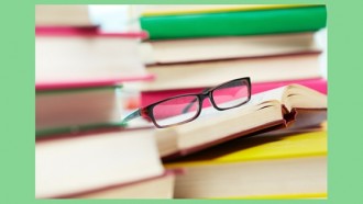 stack of reference books and a pair of glasses