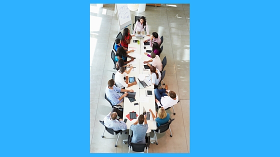 People gathered around a desk - staff meeting scenario