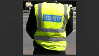 back of a person in yellow jacket with security written on it