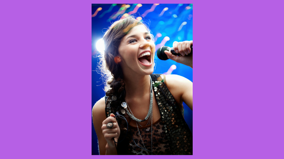 girl singing into a microphone