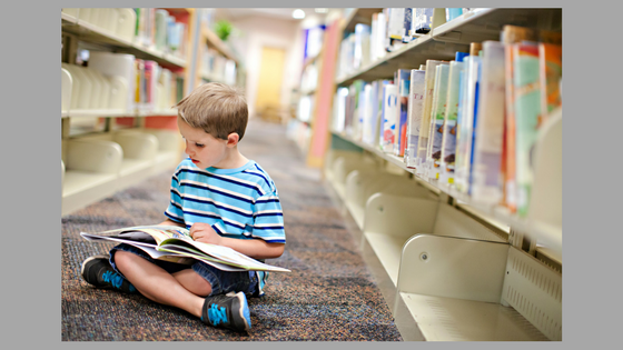 kid reading in library