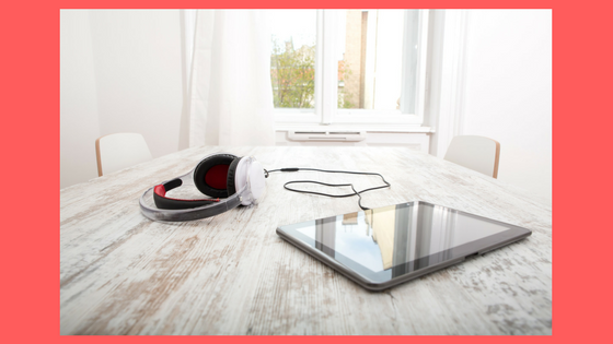 ipad and headphones on a table