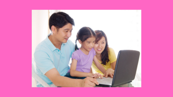 family gathered around a laptop