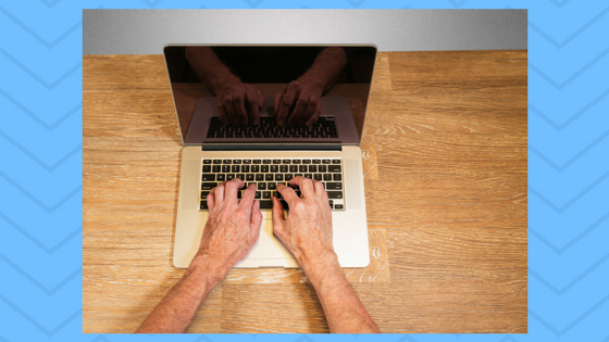 hands typing on a laptop